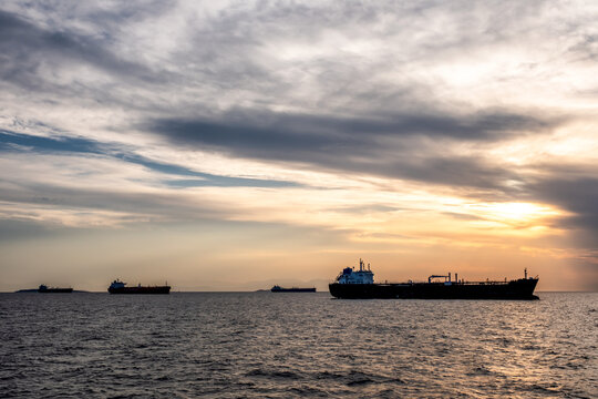 Crude oil tankers in the sea at sunset. Oil and gas industry. Tankers crude oil carrier ship designed for transporting grude oil