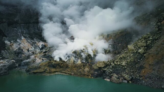 Sulfur Gas Vents and Miners Beside Acid Lake in Kawah Ijen Crater, East Java Indonesia