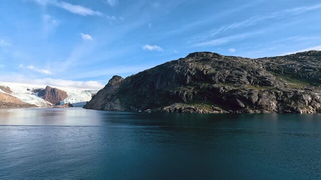 A smooth timelapse video panning across a glacier at Prince Christian Sound, Greenland, in summer. 