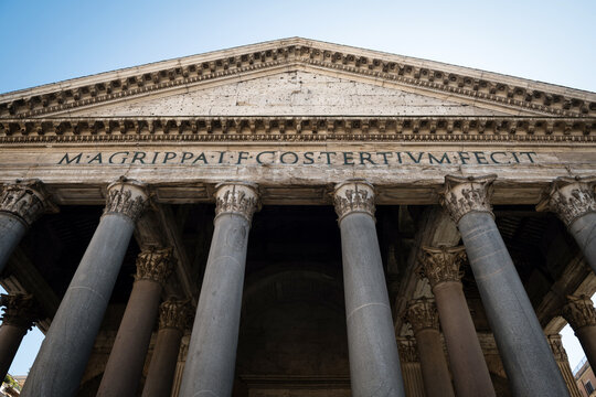 Low angle view of Corinthian columns and Marcus Agrippa Latin inscription on Pantheon portico facade in Rome, Italy