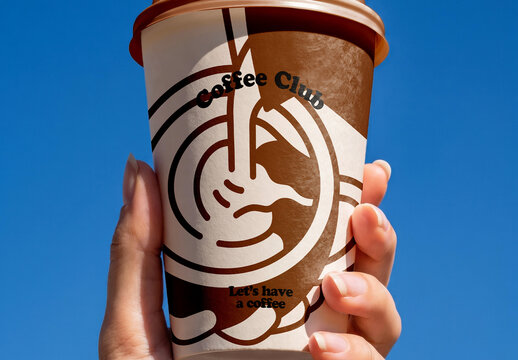 Hand Holding Paper Coffee Cup Against Sky Mockup