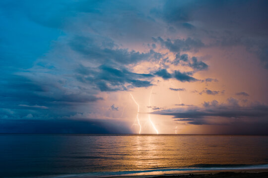 lightning in night sky over ocean