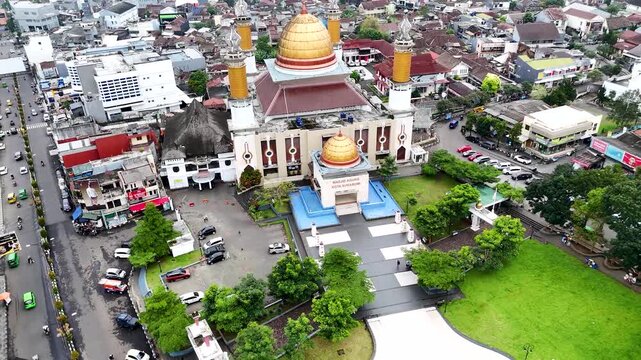 Aerial view of Masjid Agung Kota Sukabumi with its golden dome and surrounding urban landscape in Sukabumi, West Java, Indonesia.