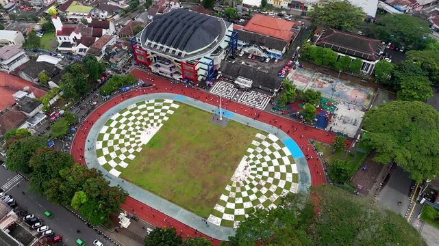 Aerial view of Lapang Merdeka Sukabumi featuring the central roundabout, surrounding urban buildings, and traffic flow in Sukabumi, West Java, Indonesia.