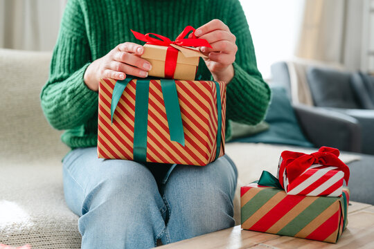  Christmas festive gifts, woman wrapping presents at home