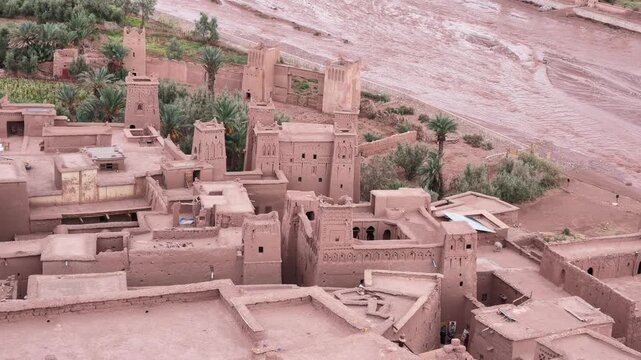 High-angle aerial view of the historic earthen defensive walls and towers of the ancient fortified ksar at A&iuml;t Benhaddou in Morocco