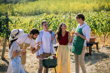 Naklejka premium Friends preparing food together during a vineyard picnic