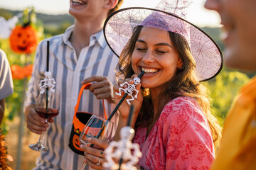 Naklejka premium Woman in witch costume enjoying a Halloween vineyard celebration
