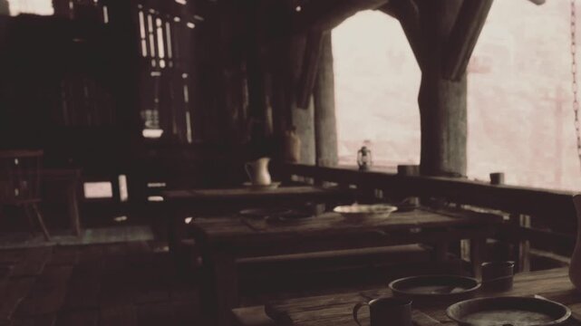 In a dimly lit room, wooden tables sit empty, adorned with simple plates and cups. The atmosphere feels historic, evoking a sense of stories waiting to be shared.