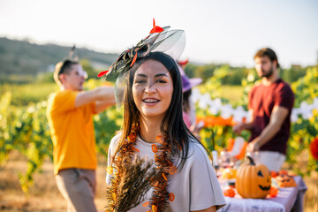 Naklejka premium Woman wearing a creative Halloween headpiece during a vineyard celebration