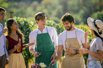 Naklejka premium Group of friends chatting beside an outdoor food preparation station