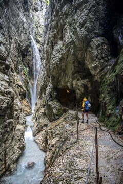Hiker in a gorge, Hammersbach flows through H&ouml;llentalklamm, near Garmisch-Partenkirchen, Werdenfelser Land, Upper Bavaria, Bavaria, Germany