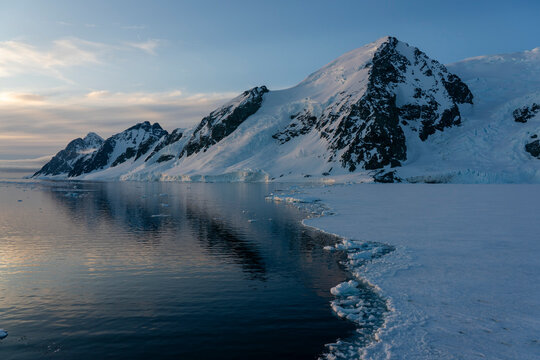 Fast ice and snow covered mountains in Bourgeois Fjord, Marguerite Bay, Antarctica,