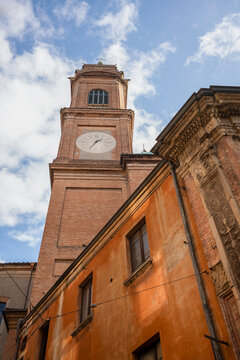 Looking up at the clock tower of Basilica of Saints Bartholomew and Gaetano in the historic University city of Bologna,