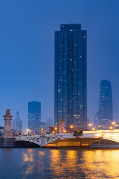 Junlin Mansion, Bei'an bridge with Tianjin World Financial Centre in the background at dusk, Tianjin, China