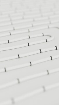 White pipes on white floor. Construction of underfloor heating system. Animation of water pipes for house warming. Radiant hydronic heating. Vertical Video.