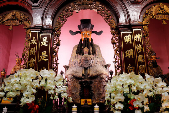 Chua Phuoc Hai, Jade Emperor Pagoda. Taoist statue with black hat and beard enthroned amid golden calligraphy panels. Ho Chi Minh city. Vietnam.