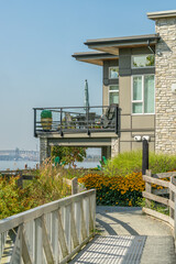 Fototapeta premium Waterfront Contemporary Home with Balcony, Garden and Walking Path
