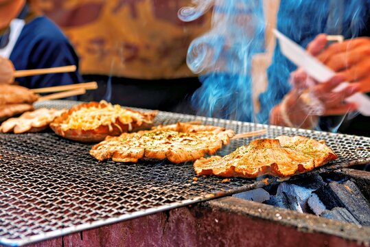 Giant wild mushrooms on a charcoal grill in Yufuin, Oita, Kyushu, Japan