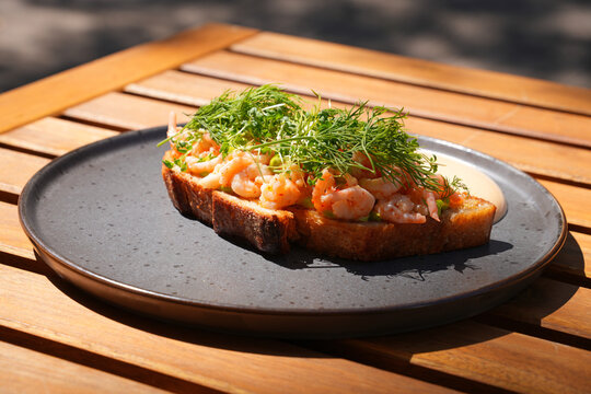 Traditional Scandinavian shrimp toast (toast Skagen) with dill, egg and mayonnaise