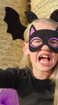 Girl in halloween bat costume scaring people