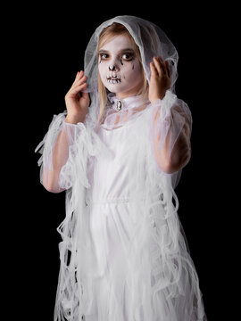 A young girl in a spooky ghost Halloween costume