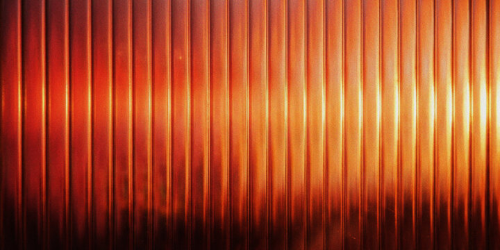 Abstract background of vertical metallic ridges with warm orange and red lighting