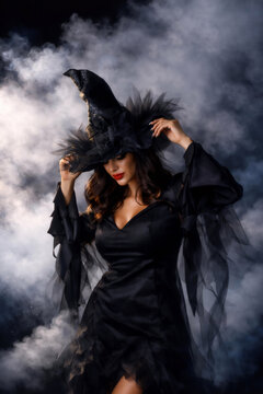 Sexy young brunette woman in mist in witch halloween party costume