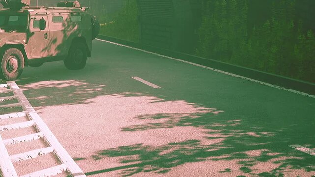 A military vehicle stands still on the road beside a tunnel, casting shadows on the pavement. The vibrant green foliage adds a serene contrast to the scene, highlighting natures beauty.