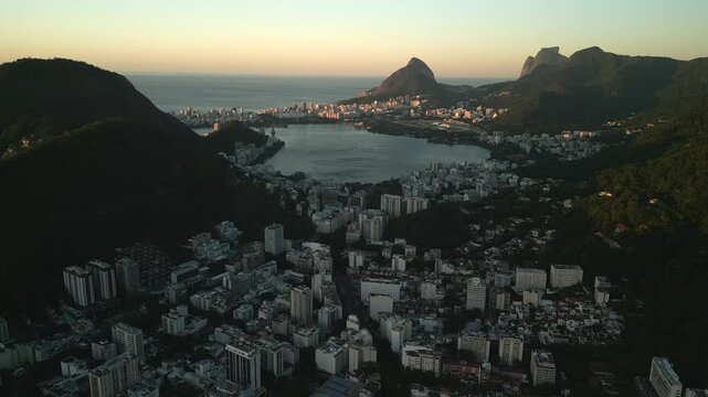 Aerial view of Rodrigo de Freitas Lagoon surrounded by urban buildings and mountains in Rio de Janeiro, Brazil.