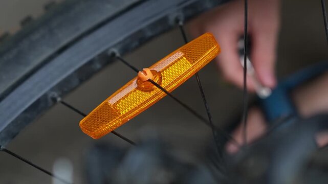 Bicycle wheel light reflector installation. Preparing your bike for the season. Updating parts, riding safety. Installing reflectors on wheels