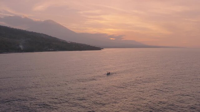 Lipah Beach in Amed, Bali, Indonesia, showing the calm sea at dusk - drone shot