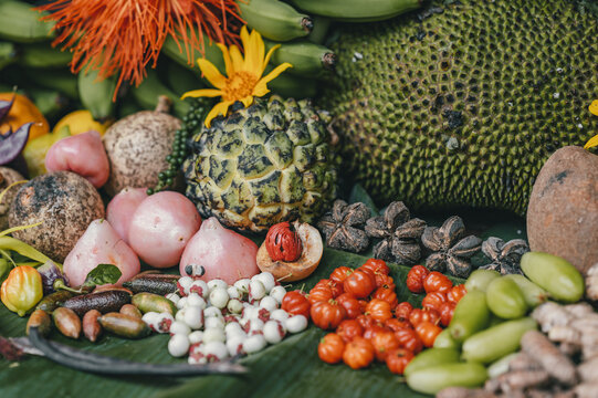 View of a colorful assortment of fresh tropical fruits including jackfruit, custard apple, and star fruit arranged on a large green leaf in Puerto Viejo de Talamanca, Limon Province, Costa Rica.