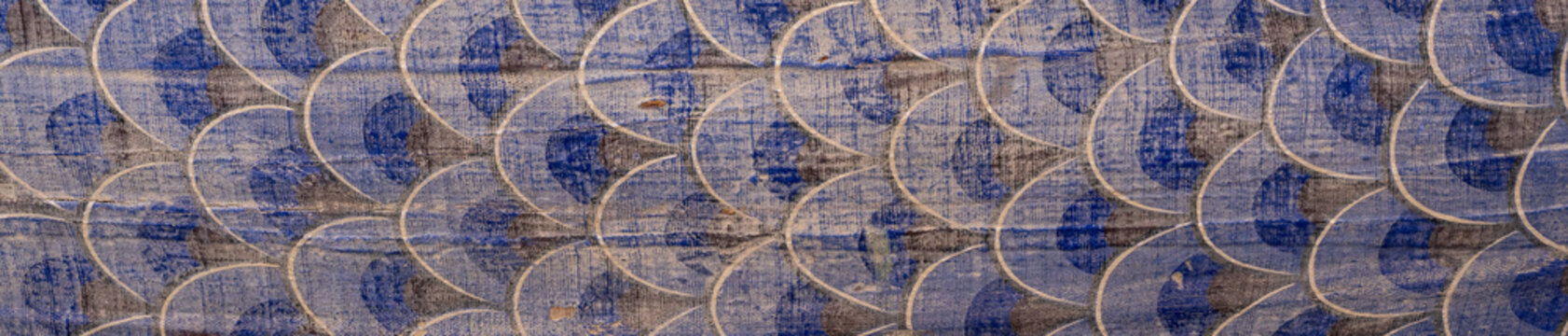 Vintage painted wooden fish scale pattern of traditional percussion instrument at Korean Buddhist temple for background and texture.