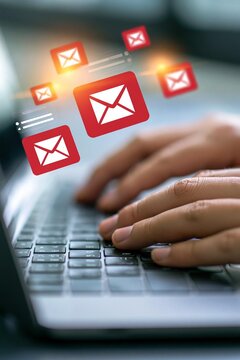 Hands checking email notification on laptop with floating mail icons, showing new email alert, inbox message update, digital communication, online notification, office workspace.
