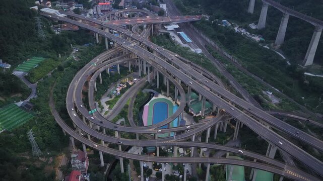 Aerial view of a complex multi-level highway interchange with concrete pillars and surrounding greenery in Guiyang, Guizhou, China.