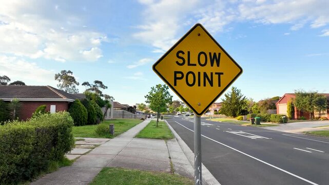A "SLOW POINT" warning sign leading to a traffic calming chicane curb on a suburban residential street in&nbsp;Melbourne, Australia, designed to force vehicles to slow down when navigating the bend