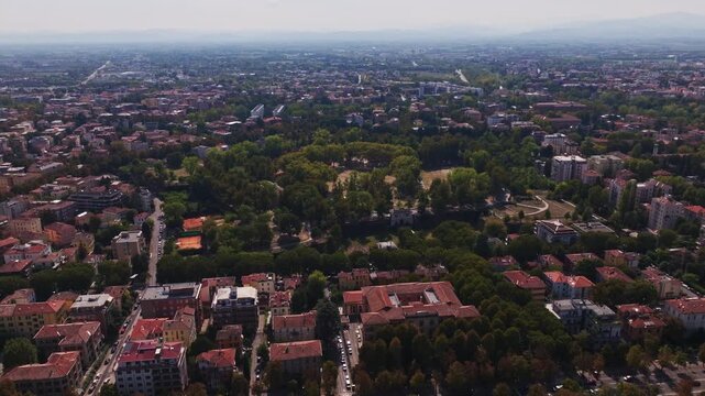 Aerial drone view of Parco della Cittadella in Parma, Italy, showcasing the historic fortress walls, pentagonal park, lush greenery, walking paths, and surrounding cityscape.
