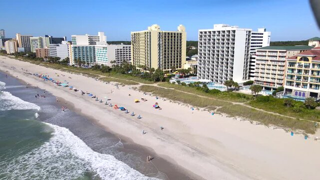  Resort buildings overlook swimmers and broad sand along the South Carolina waterfront.
