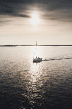 View of a sailboat sailing on the calm sea near Vormsi during golden hour in Laane County, Estonia.