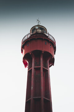 View of the red metal Ristna Lighthouse standing against a clear sky in Kalana, Hiiu maakond, Estonia.