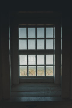 View of the forest landscape seen through the grid window of the historic Kopu Lighthouse, Magipe, Hiiu maakond, Estonia.