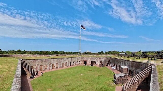  Fort Macon interior fills a wide view framed by ramparts and artillery.
