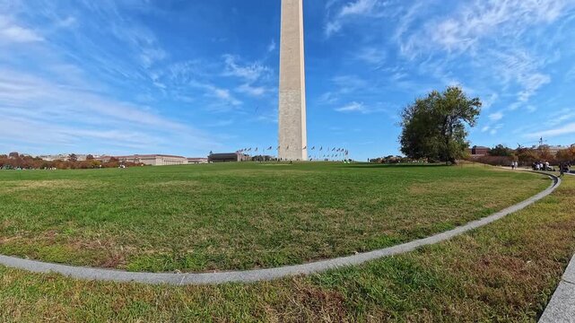 Washington Monument emerges above a broad green lawn in this widening 4K video.