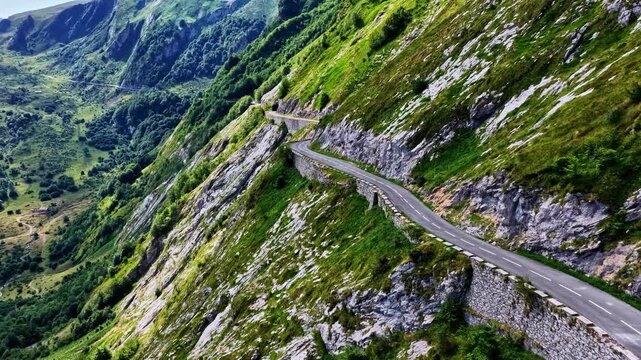 Aerial view of the winding Col d'Aubisque mountain road carved into the steep, rocky slopes of the Pyrenees in Beost, Nouvelle-Aquitaine, France.
