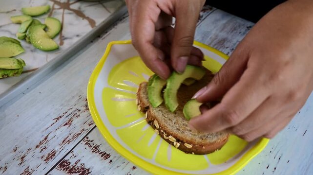 Person preparing a healthy avocado quail egg toast
