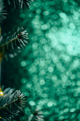 Festive Fir Branches with emerald green bokeh.festive background for Christmas greetings,mobile advertising,social media stories,holiday invitations and seasonal promotions.  © Yuliya
