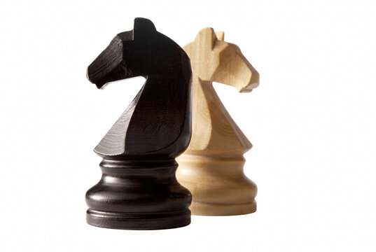 Two Wooden Knight Chess Pieces Facing Opposite Directions