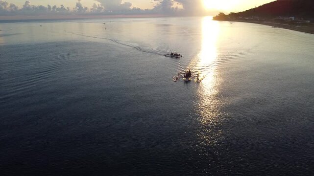 Fishermen return in the morning with their outrigger boats to the black beach of Amed, Amed Bali, Indonesia