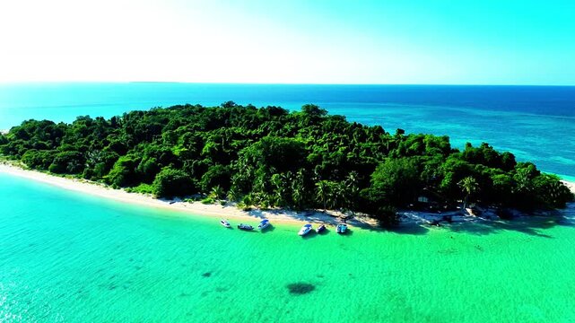 Aerial view of Sangalaki Island featuring turquoise waters, coral reefs, and white sandy beaches in Berau, East Kalimantan, Indonesia.